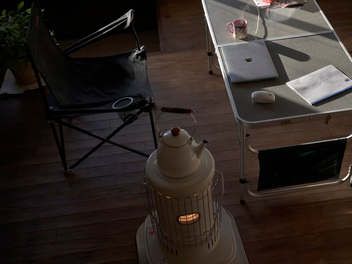 A staged home treatment scene showing a pest control setup with a portable heat machine, a steam cleaner, spray equipment, mattress encasements, and an empty bedroom prepared for bed bug treatment