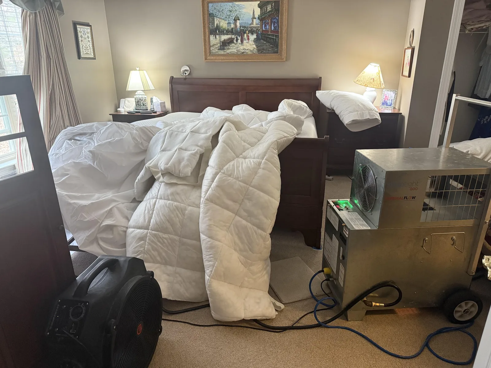 Bedroom with belongings bagged and heater ready for bed bug treatment